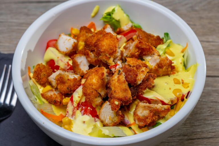 Delicious crispy chicken salad with fresh vegetables and creamy dressing.